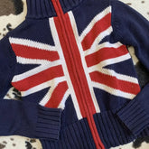 Navy blue sweater with a Union Jack design on a patterned surface